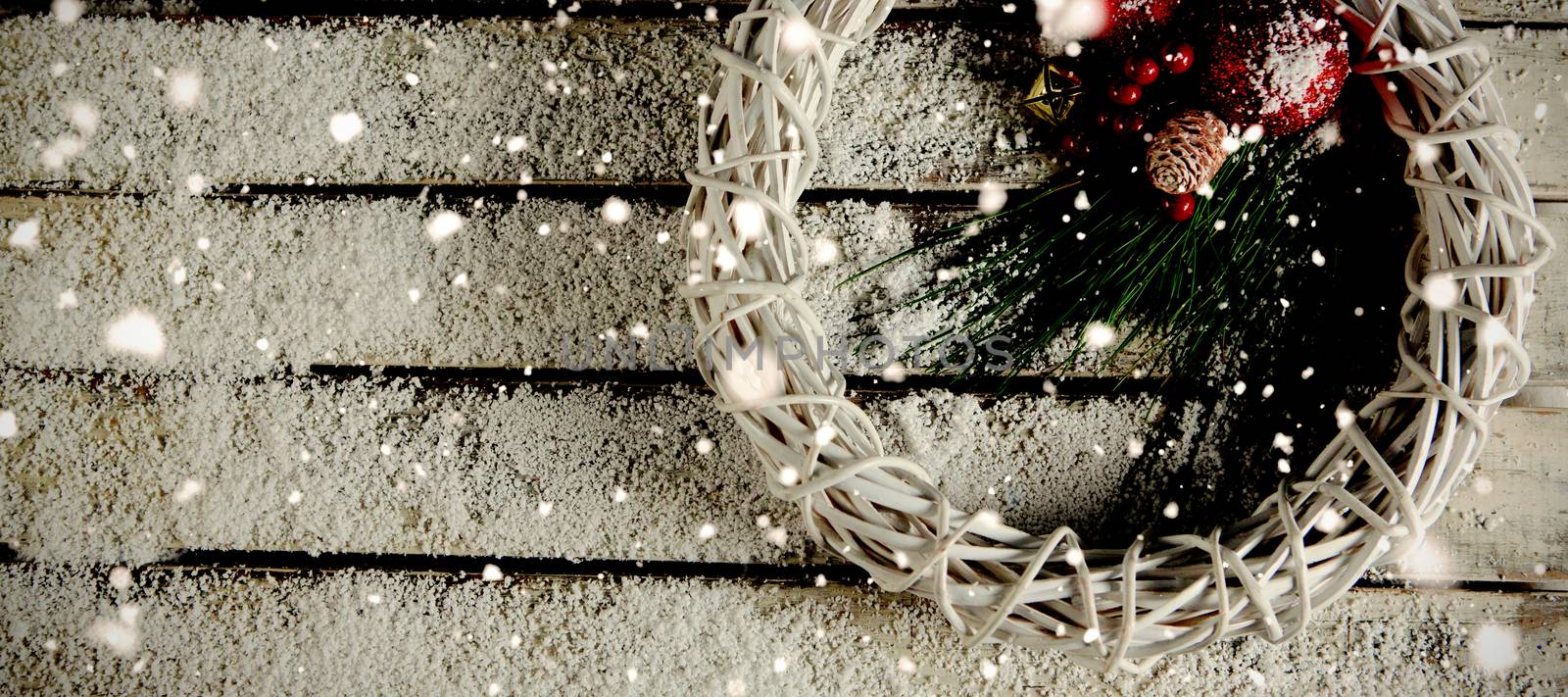 Snow falling against simple christmas crown in the snow