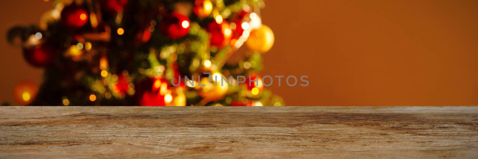 modern wooden table against copy space with a christmas tree