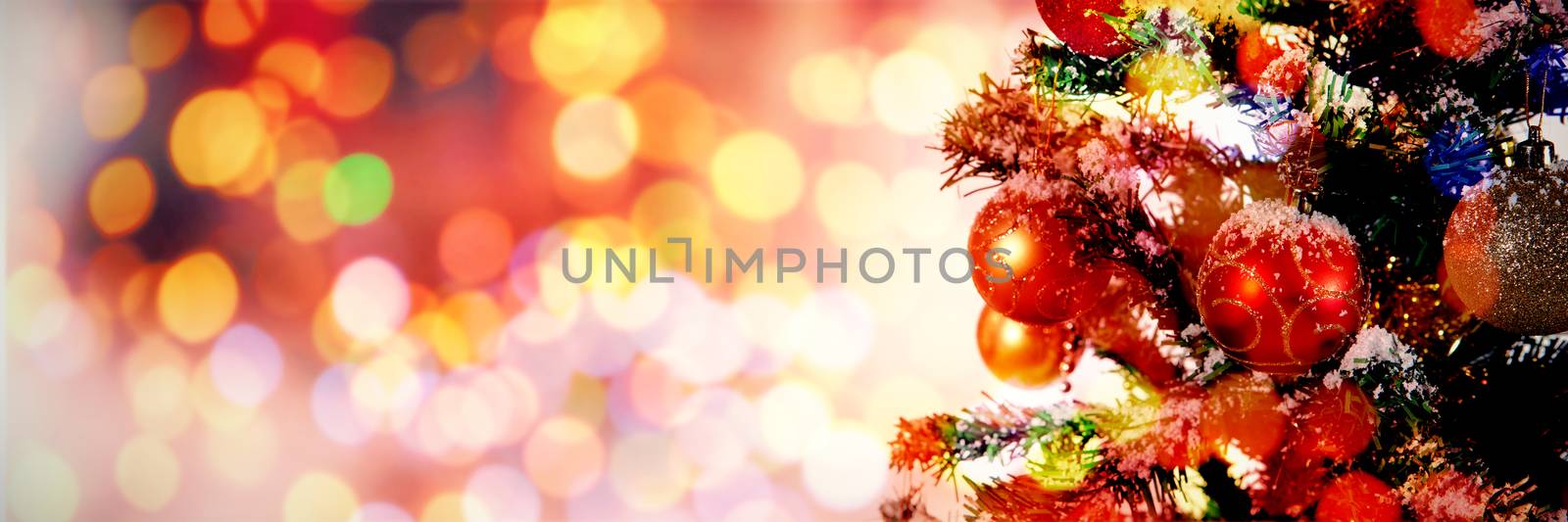 Christmas yellow circle lights against christmas decorations hanging in tree