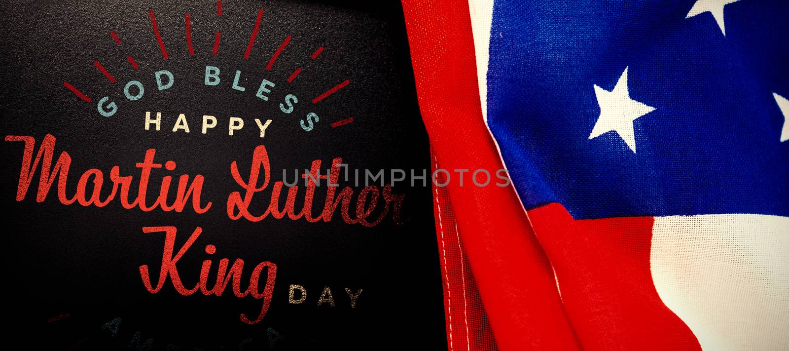 happy Martin Luther King day, god bless america against american flag and blank slate on wooden table