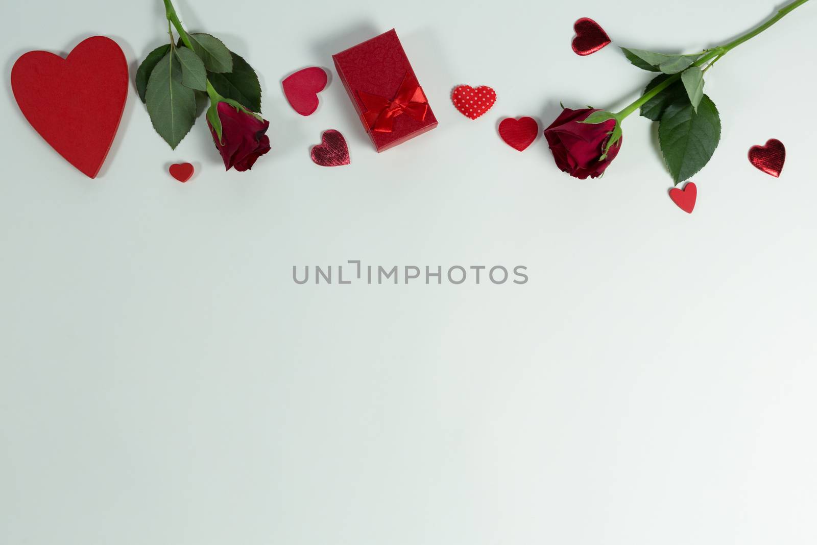 Overhead of Valentine gifts and decorations on white background