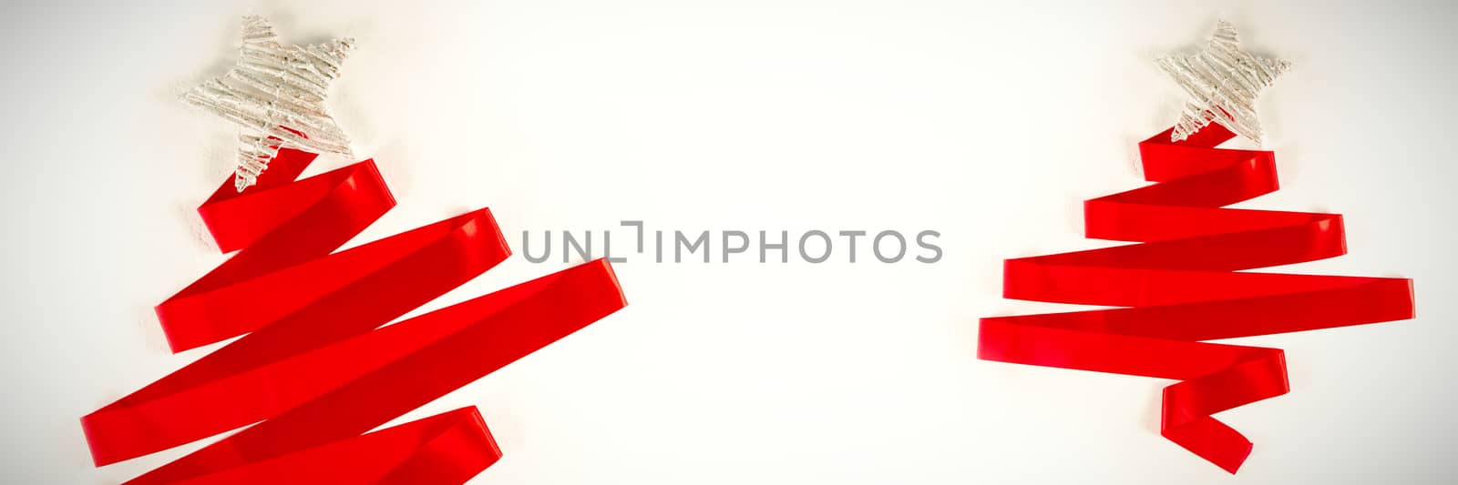 red ribbon in shape of a christmas tree on a white background