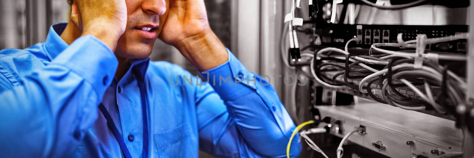 Technician getting stressed over server maintenance in server room 