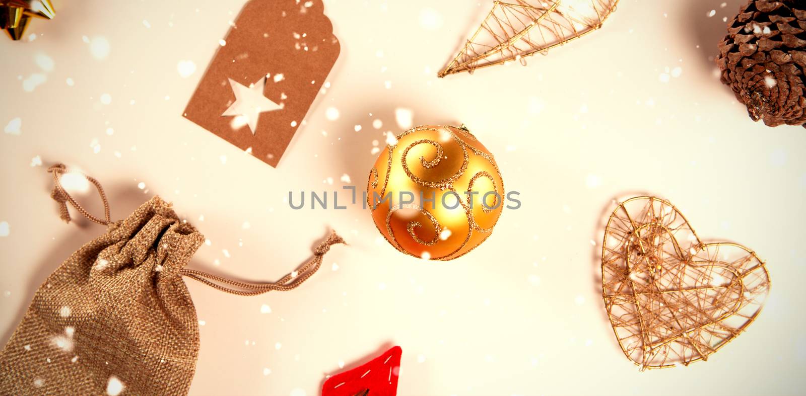 Snow falling against old christmas ornaments