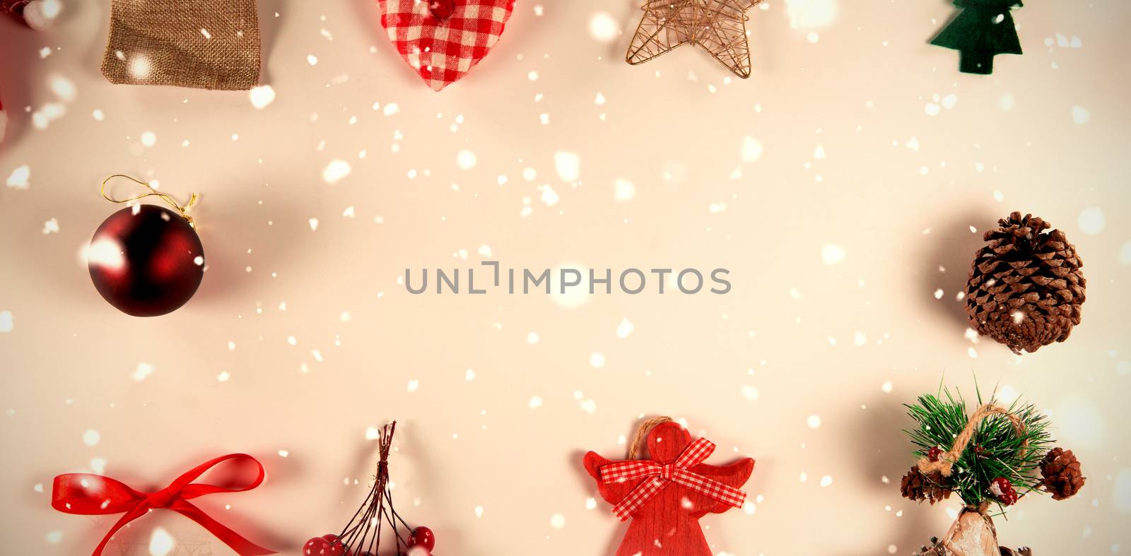 Snow falling against copy space with christmas ornaments around