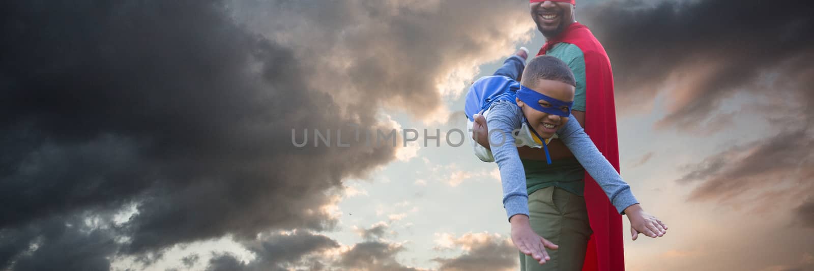 Composite image of father and son pretending to be superhero by Wavebreakmedia