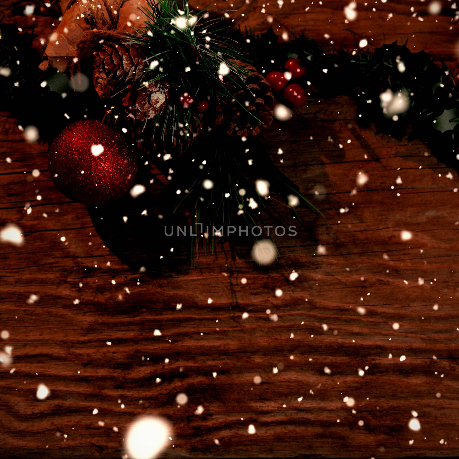 Snow falling against copy space with rustic christmas garland