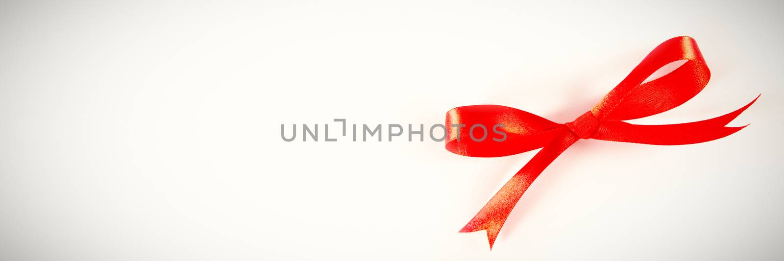 red ribbon bow, knot, lying on a white background