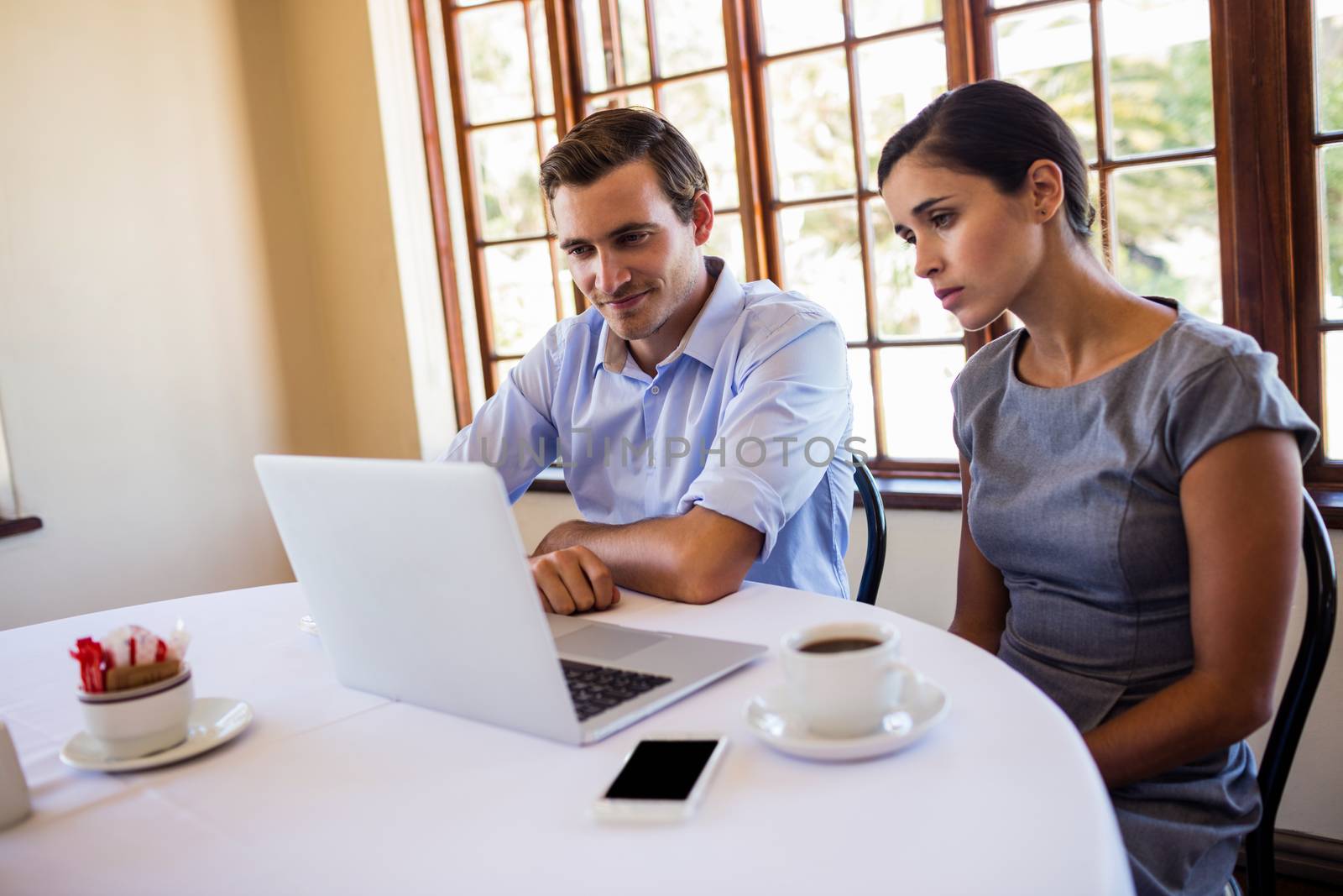 Business people discussing on laptop by Wavebreakmedia