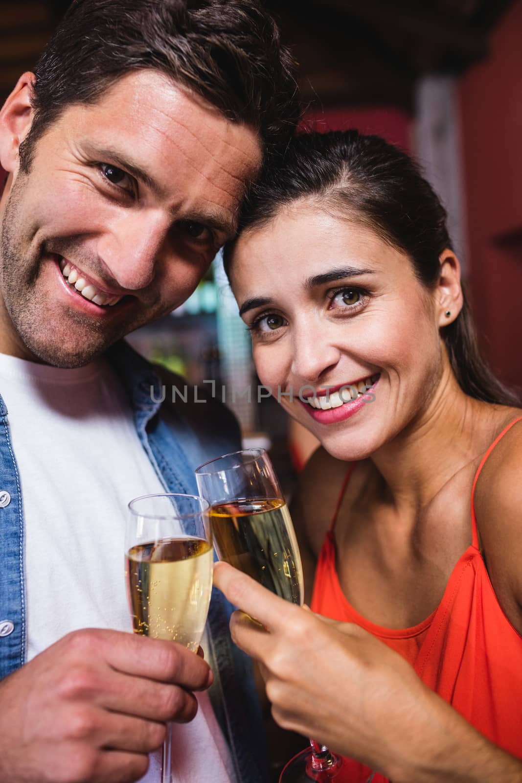 Portrait of couple enjoying champagne in nightclub