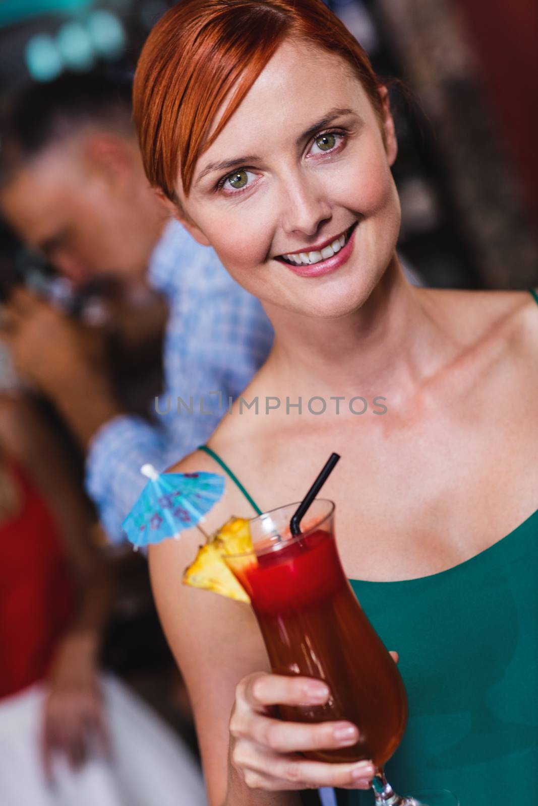 Portrait of woman enjoying cocktail in night club