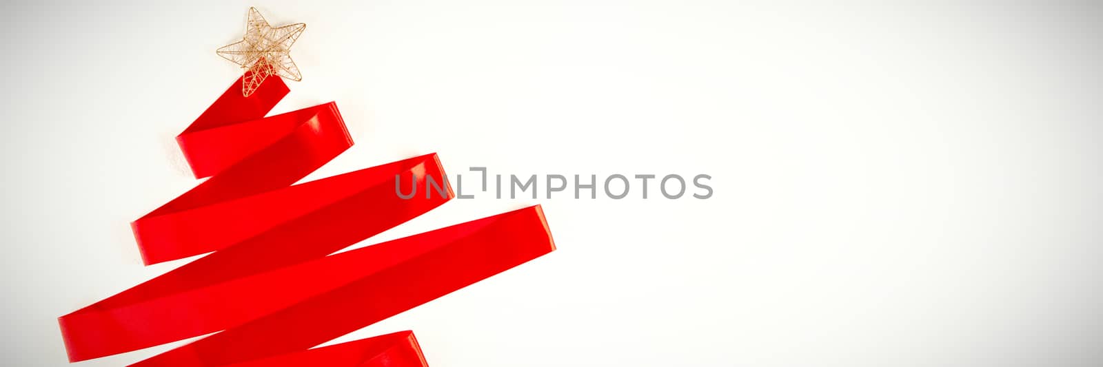 red ribbon in shape of a christmas tree on a white background