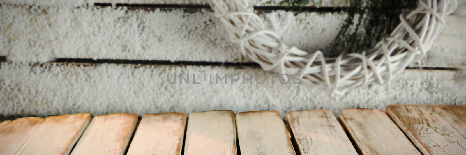 wooden boards against simple christmas crown in the snow