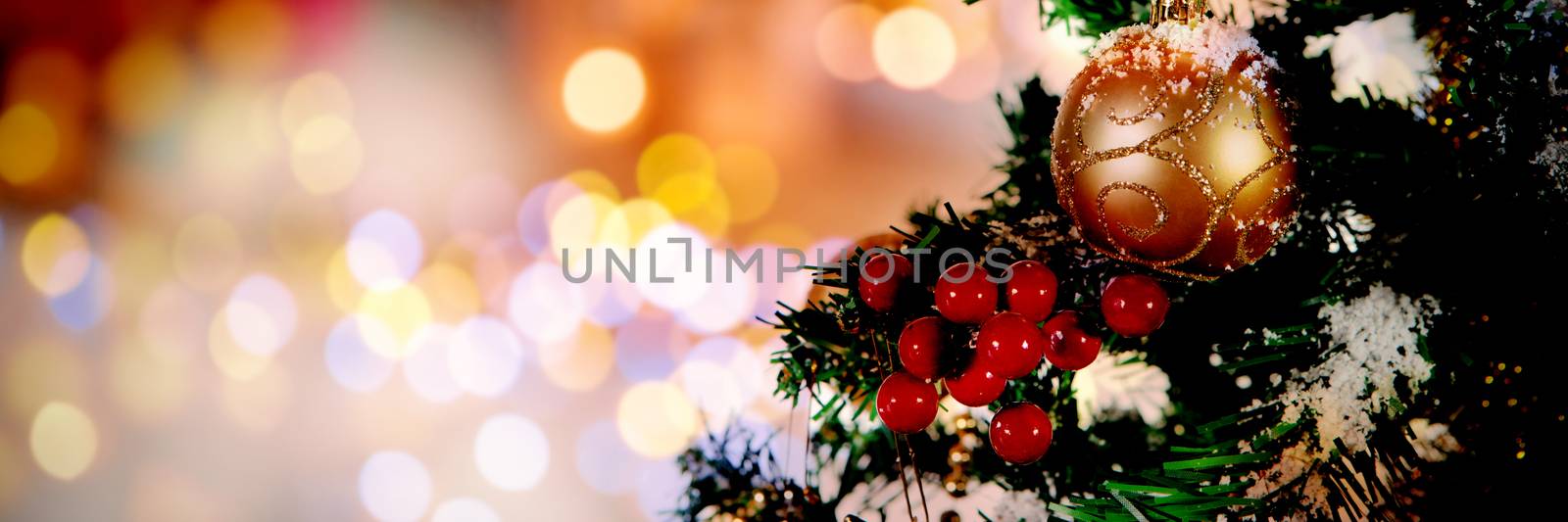 Christmas yellow circle lights against close-up of christmas tree with copy space