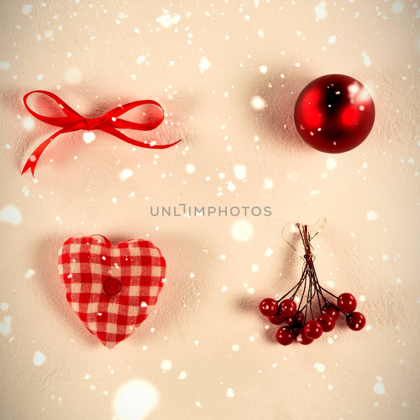 Snow falling against arranged christmas ornaments