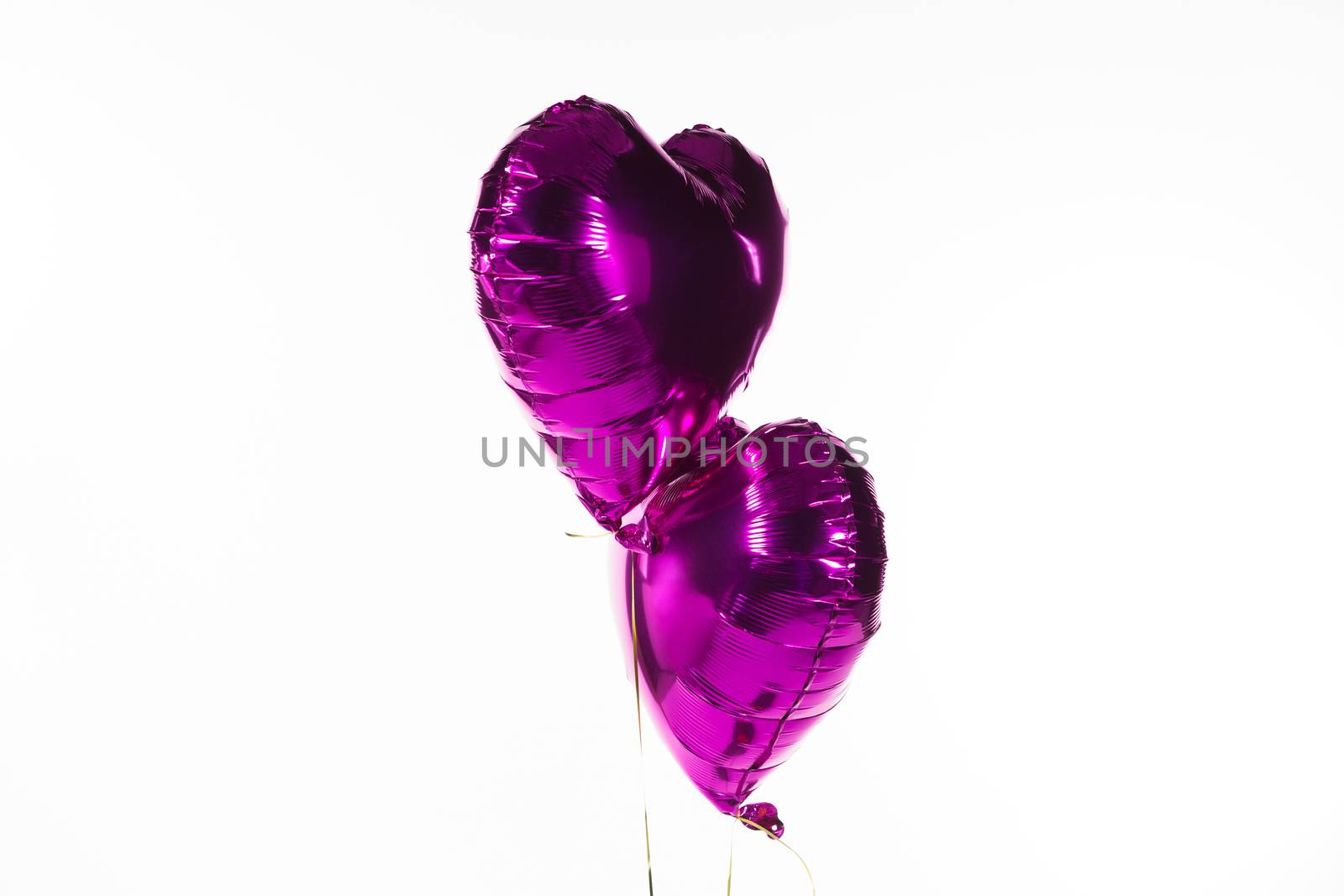 Close-up of Valentine balloons against white background