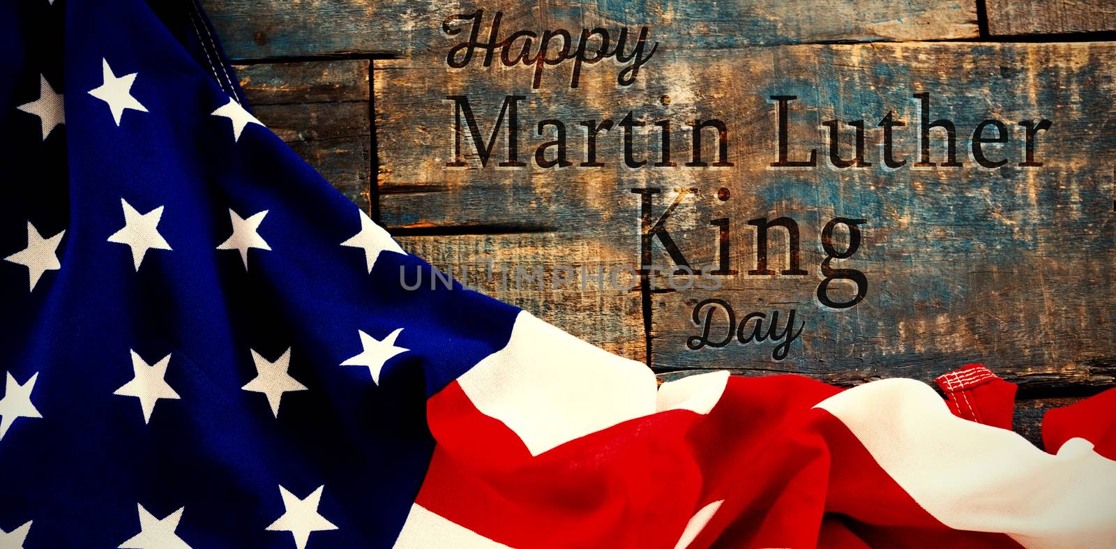 happy Martin Luther King day against american flag on a wooden table
