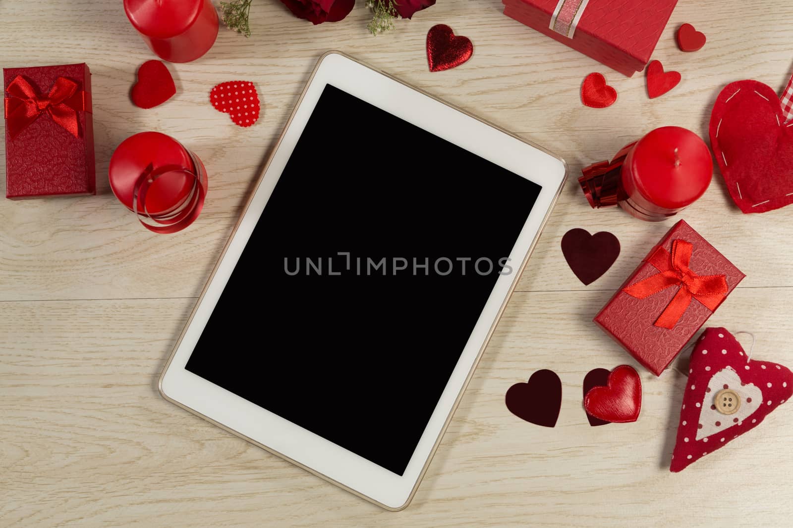 Heart shape decorations, gifts and digital tablet on wooden table