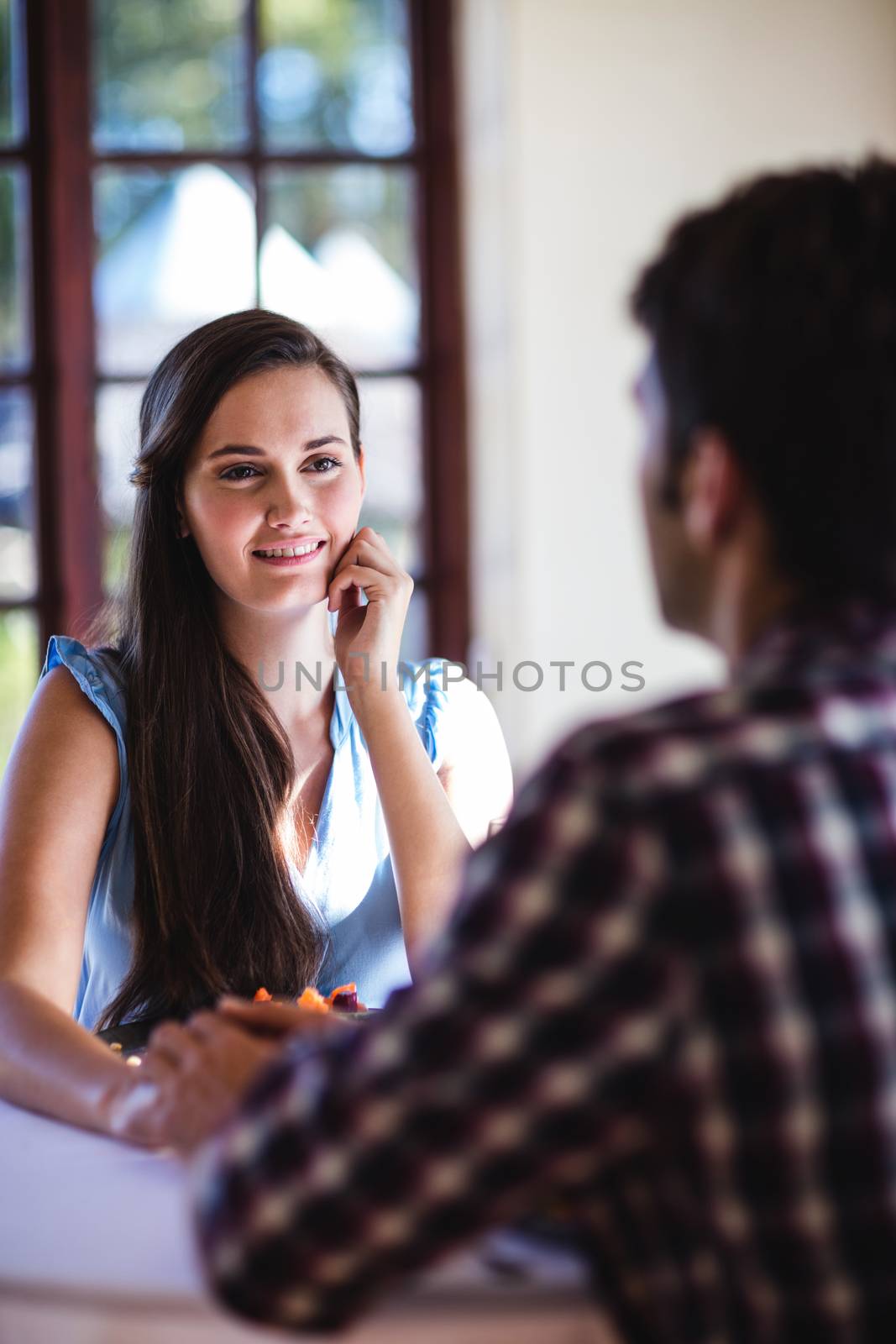 Couple holding hands in restaurant by Wavebreakmedia