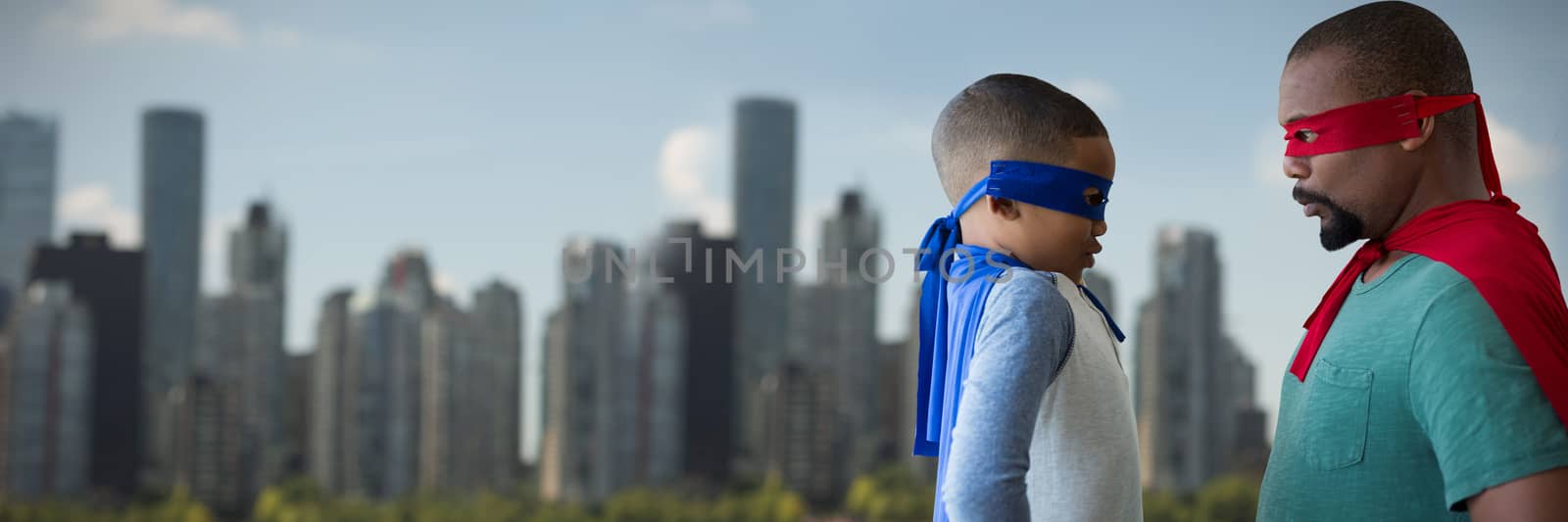 Composite image of father and son pretending to be superhero by Wavebreakmedia