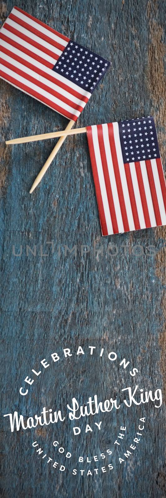 Martin Luther king day against two american flags on a wooden table