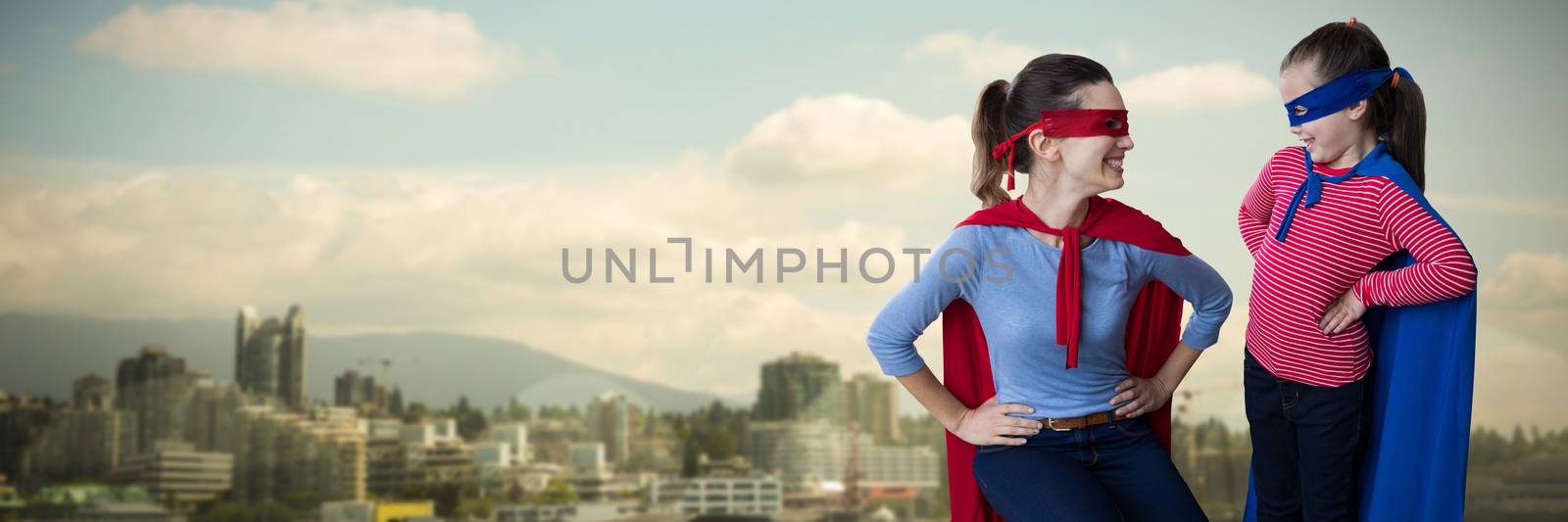 Composite image of mother and daughter pretending to be superhero by Wavebreakmedia