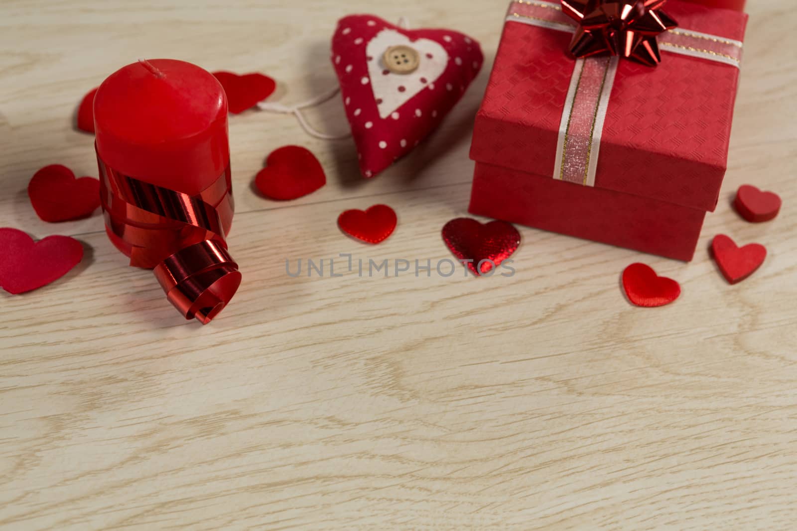 Close-up of gift boxes and heart shape decorations on wooden table