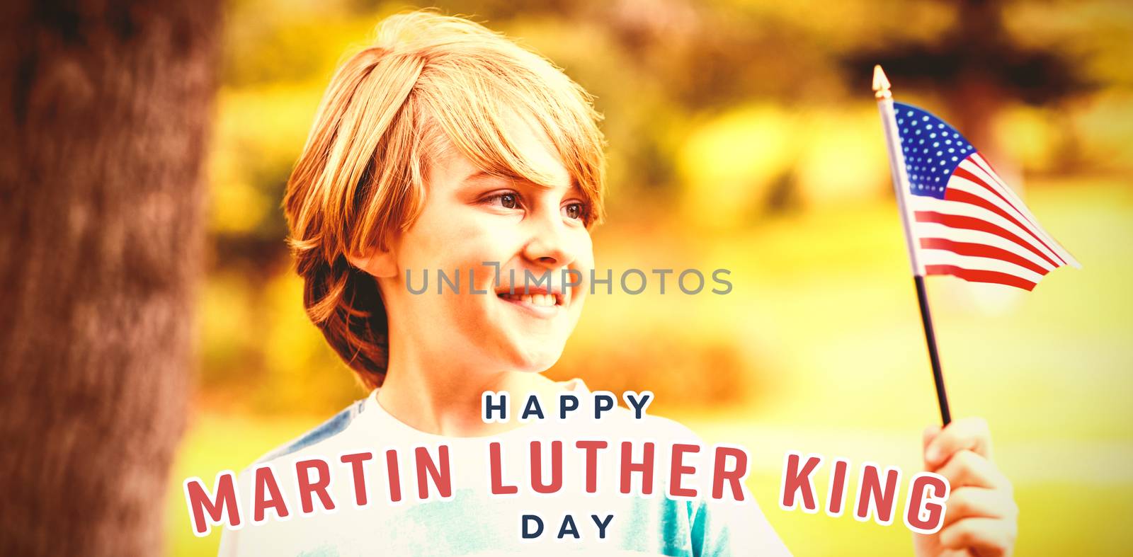 Boy looking at American flag against happy martin luther king day