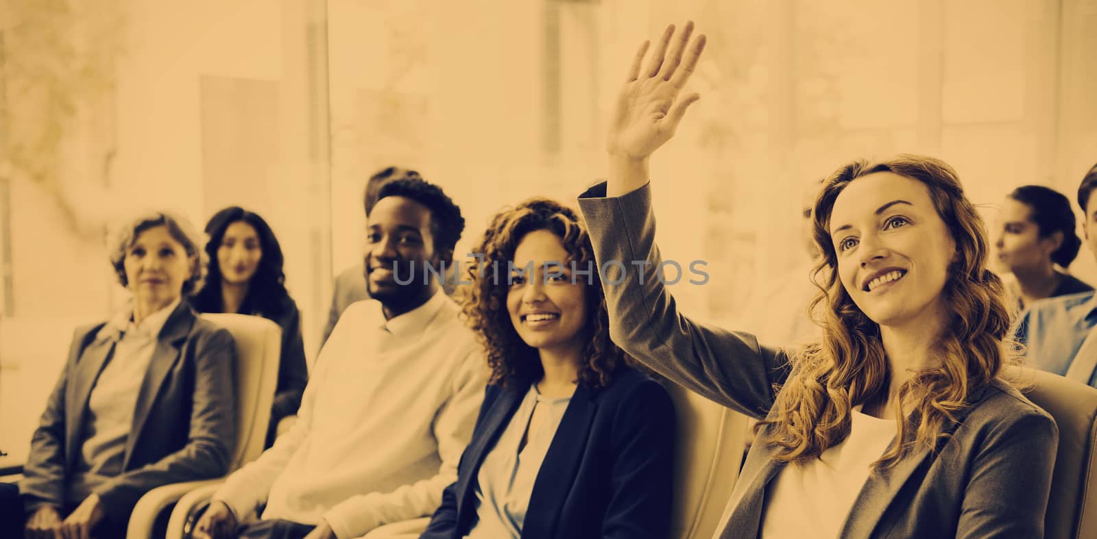 Businesswoman with colleagues raising hand during meeting in office