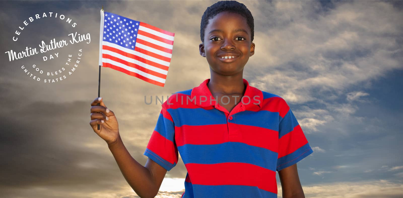 Little boy waving american flag against cloudy sky landscape