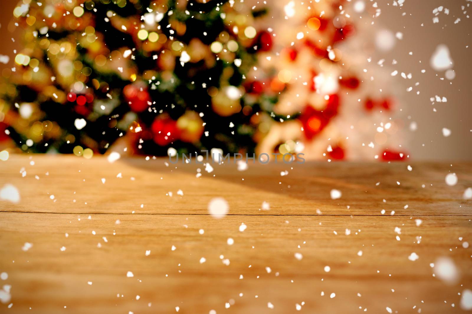 Snow falling against close-up of wooden table