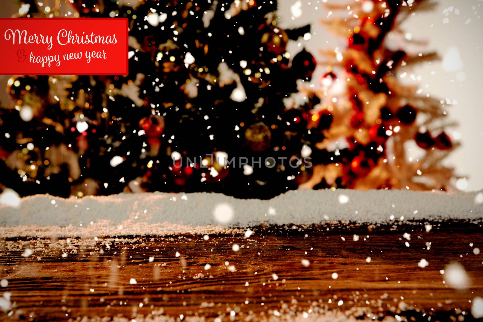 Banner Merry Christmas against wooden table with snow and unfocused christmas tree