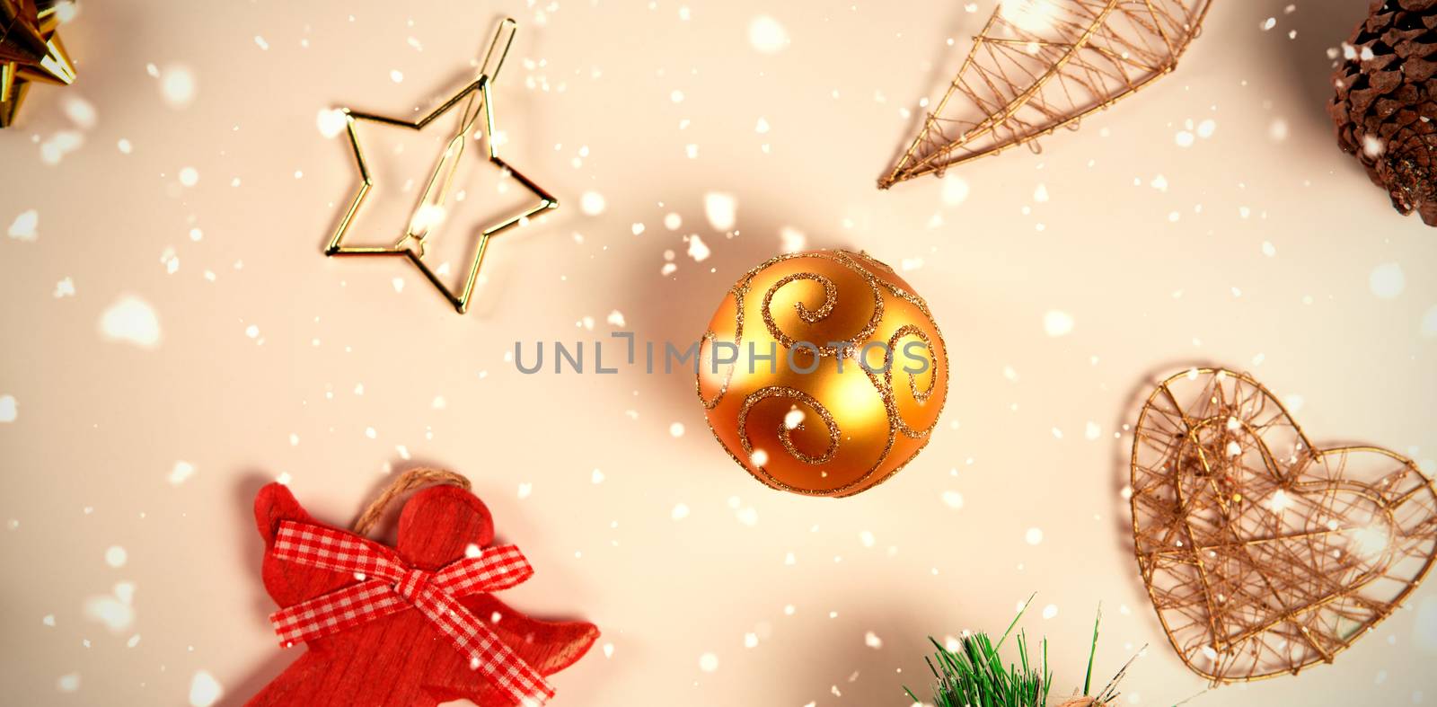 Snow falling against close-up on christmas decorations