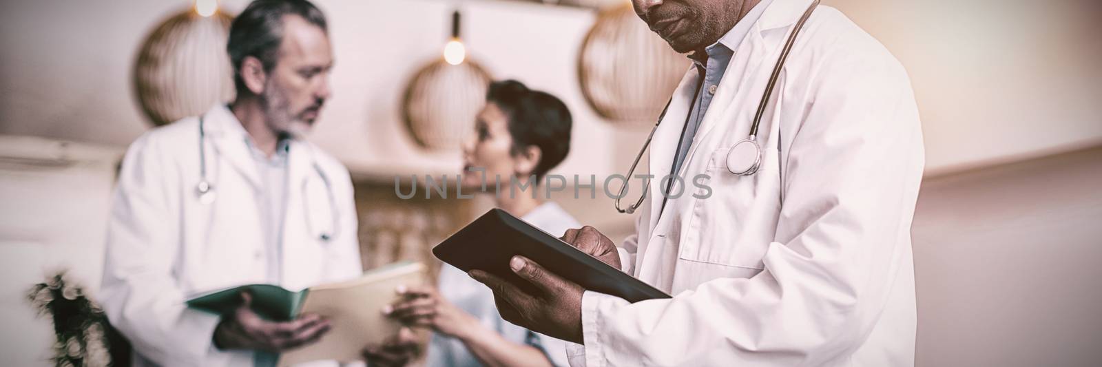 Doctor using digital tablet in hospital