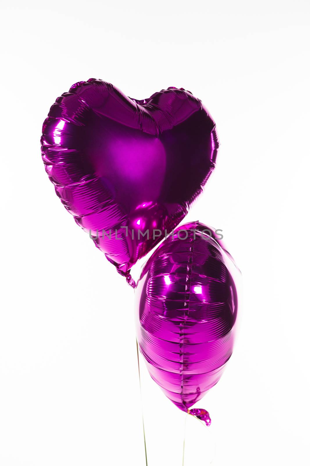Close-up of Valentine balloons against white background