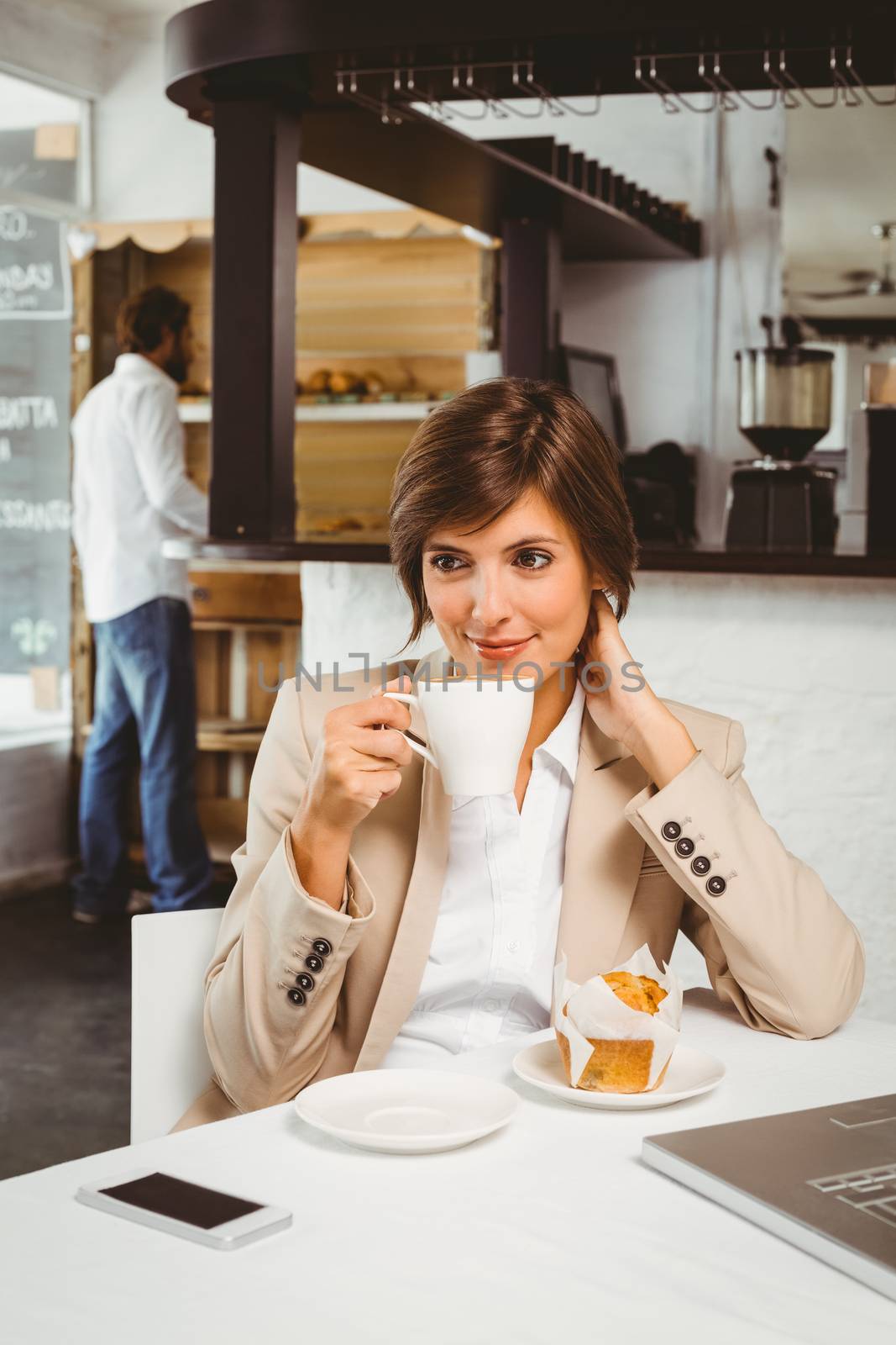 Pretty businesswoman working on her break at the coffee shop