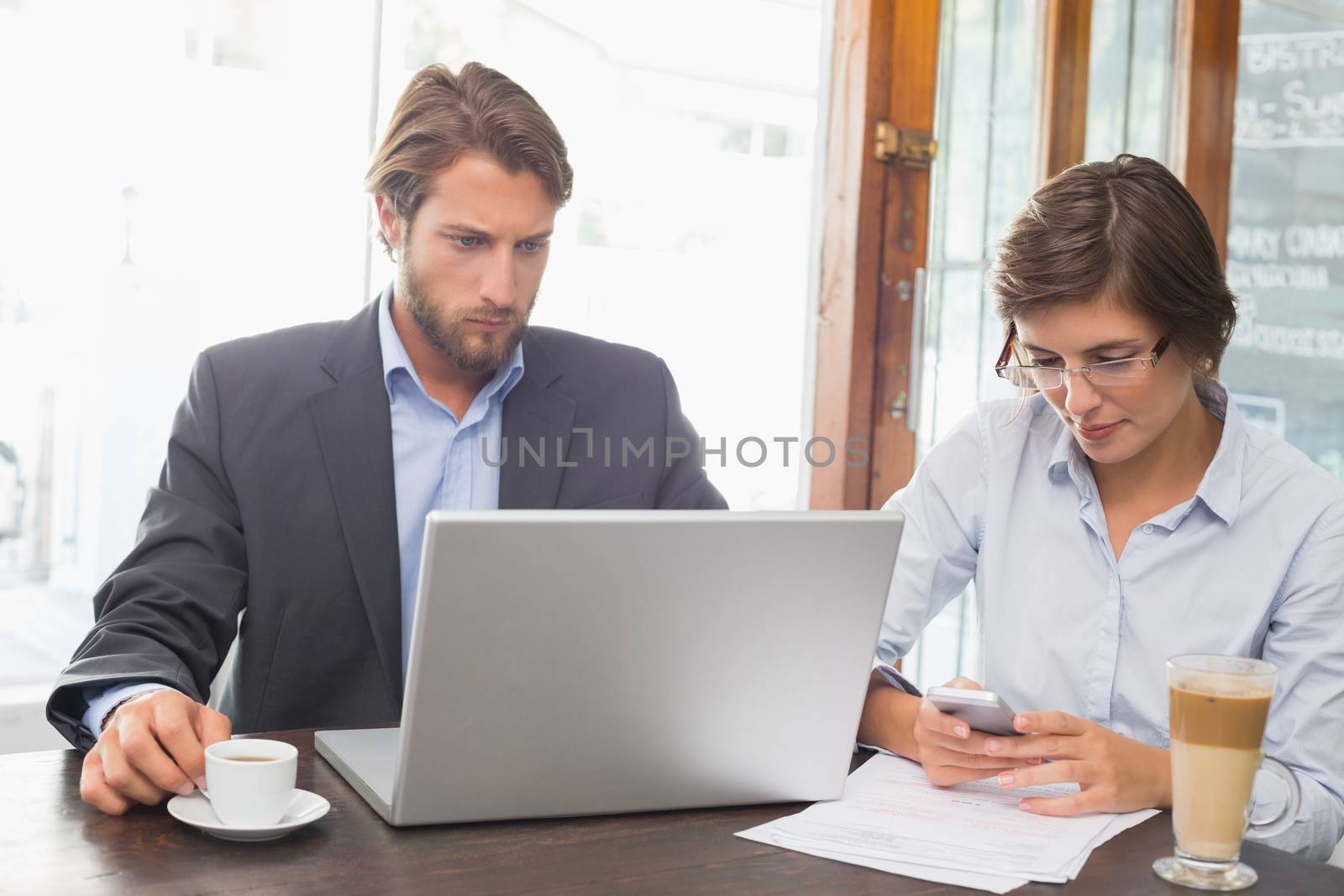 Business colleagues working on their break at the coffee shop