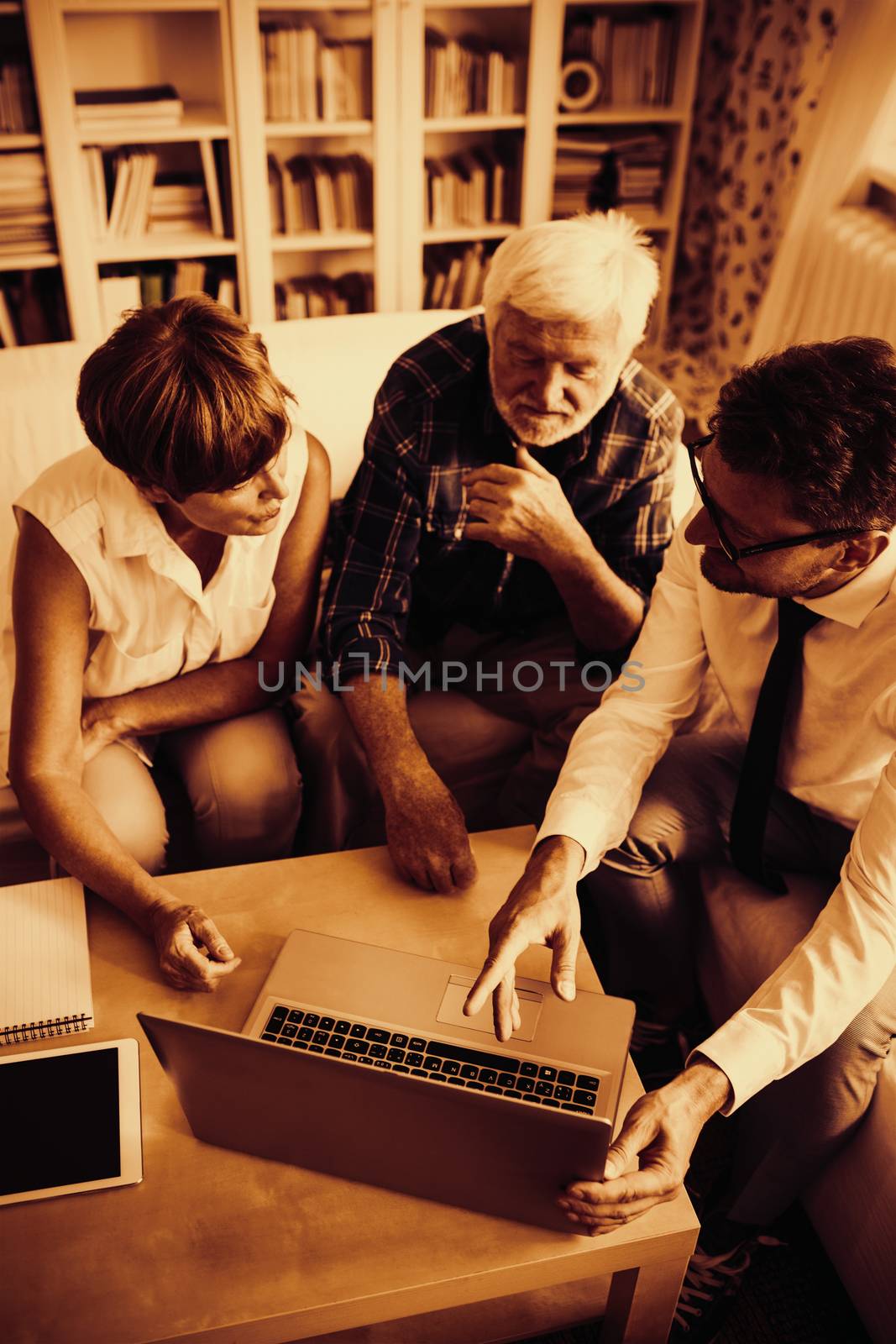 Senior couple planning their investments with financial advisor by Wavebreakmedia