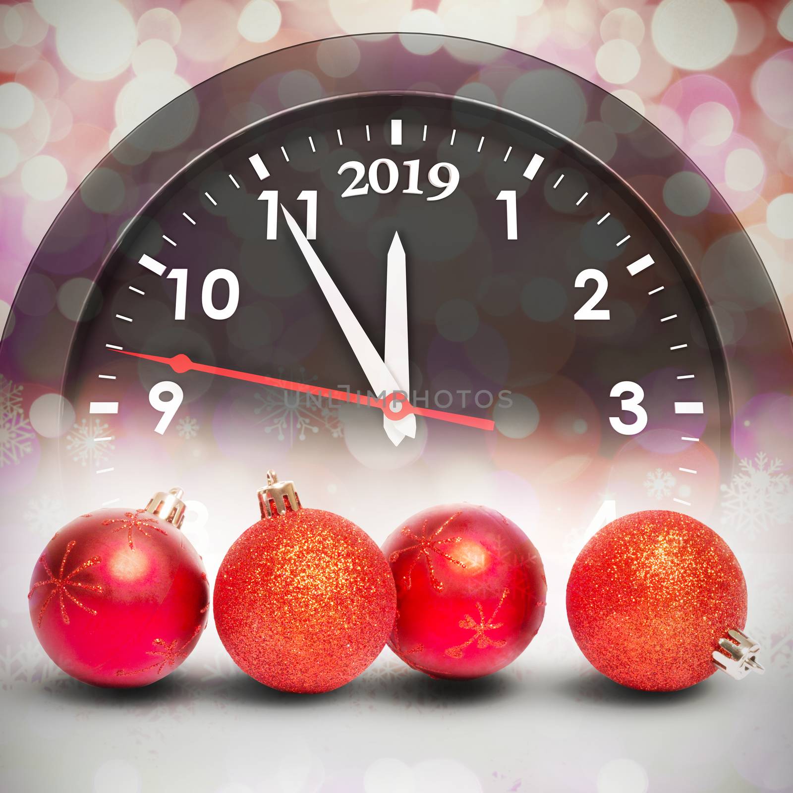 Four red christmas ball decorations against glowing christmas background