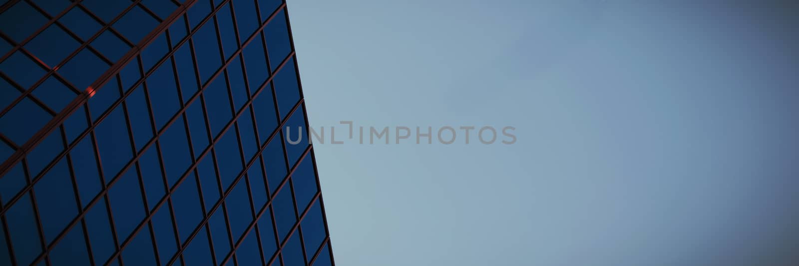 Low angle view of  office building against blue sky by Wavebreakmedia