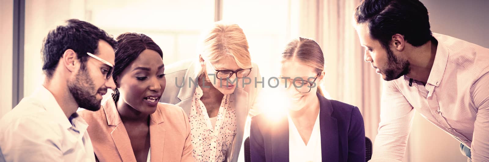 Business people interacting using laptop, mobile phone and digital tablet in the office