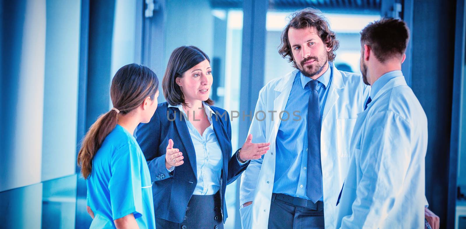 Businesswoman talking with doctors in hospital
