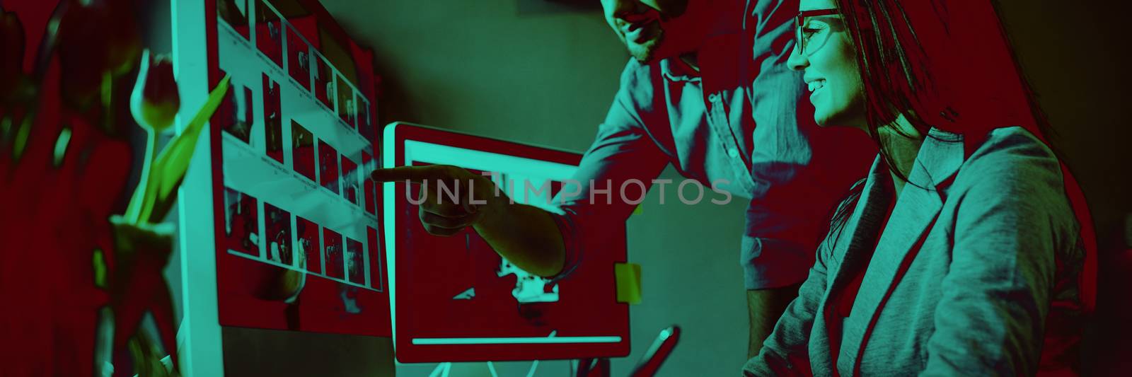 Graphic designer pointing at monitor by Wavebreakmedia