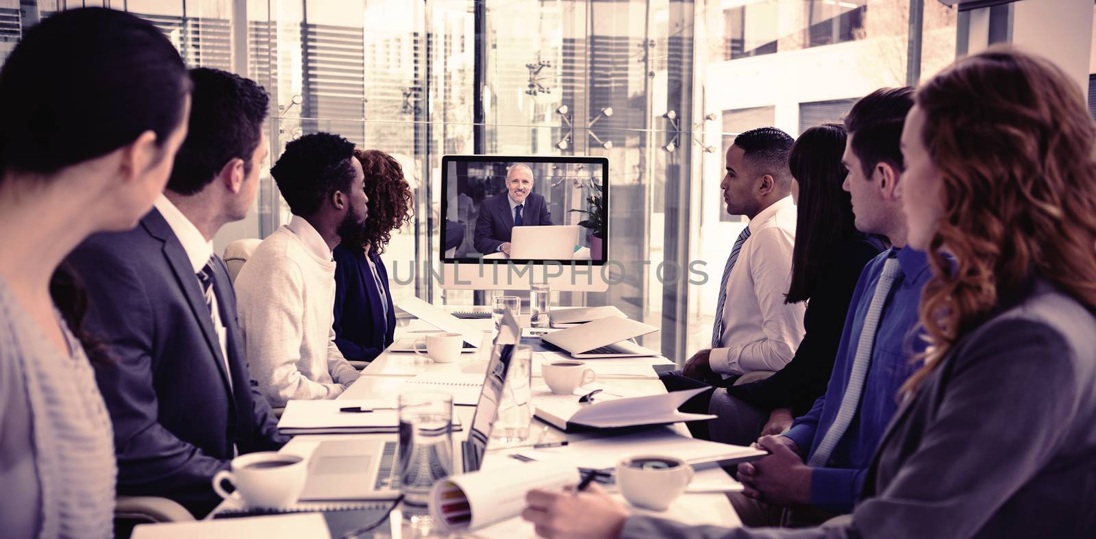 Focused business people looking at screen during video conference by Wavebreakmedia