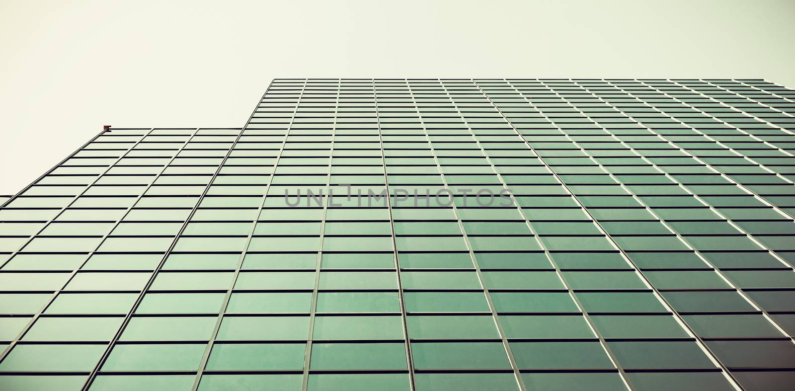 Low angle view of office building against blue sky by Wavebreakmedia