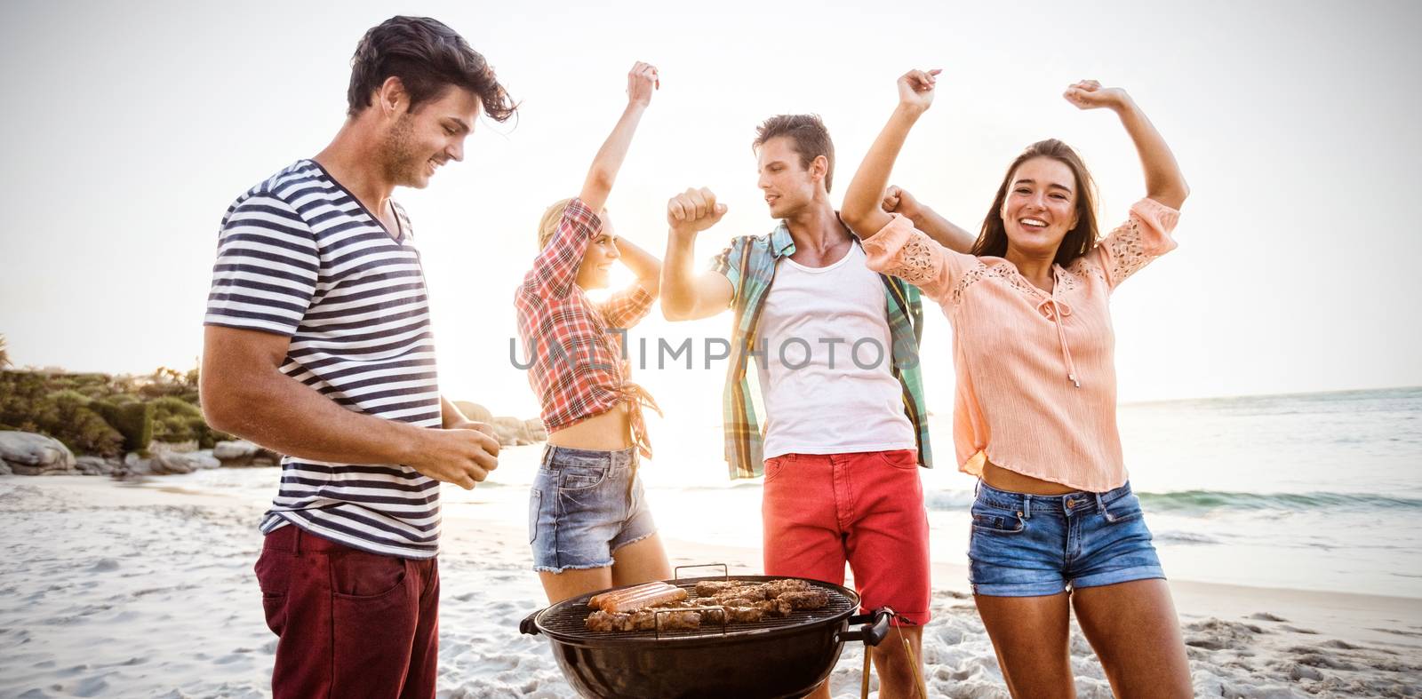 Friends having a barbecue at the beach