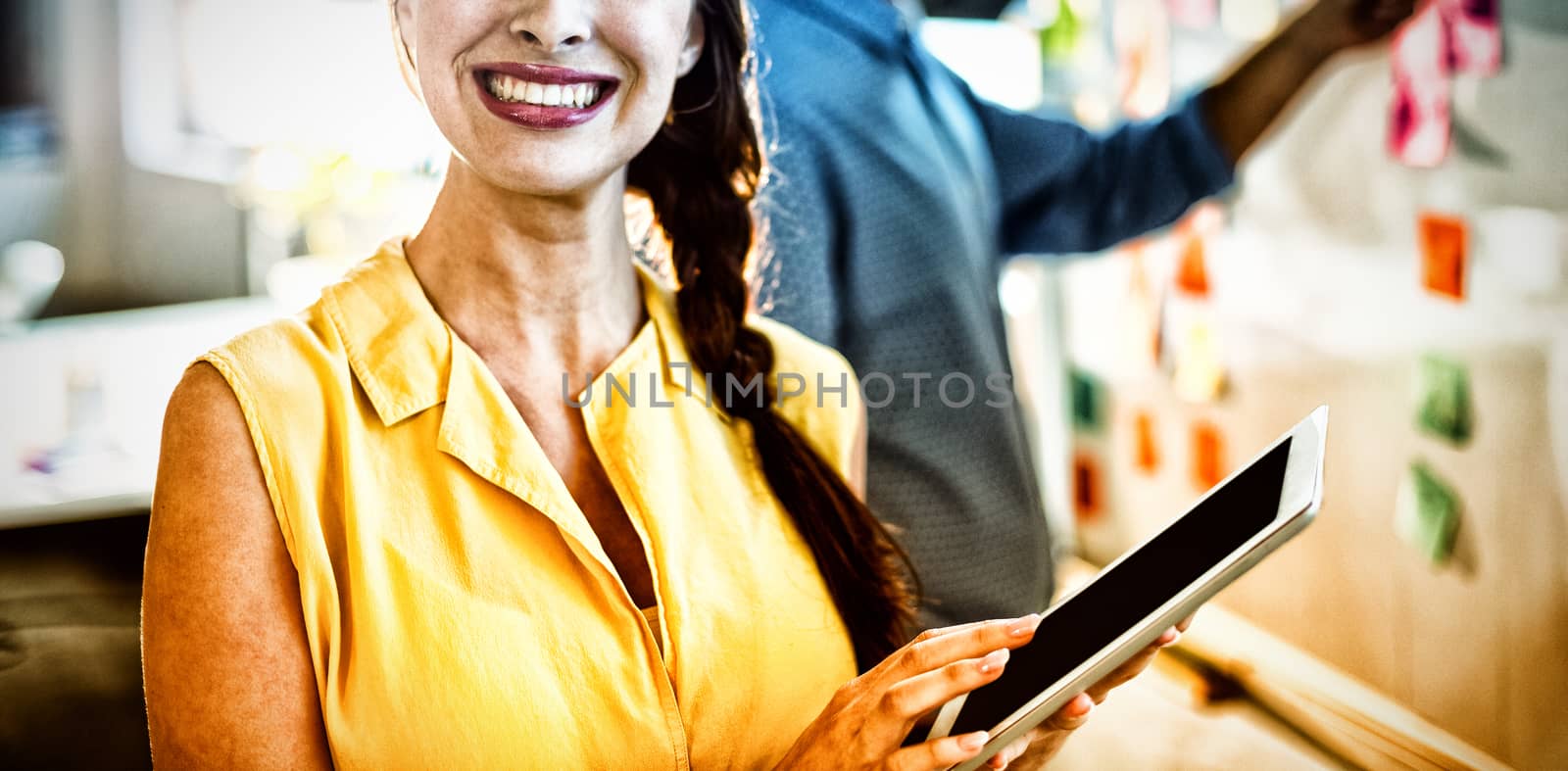 Female business executive holding digital tablet in office