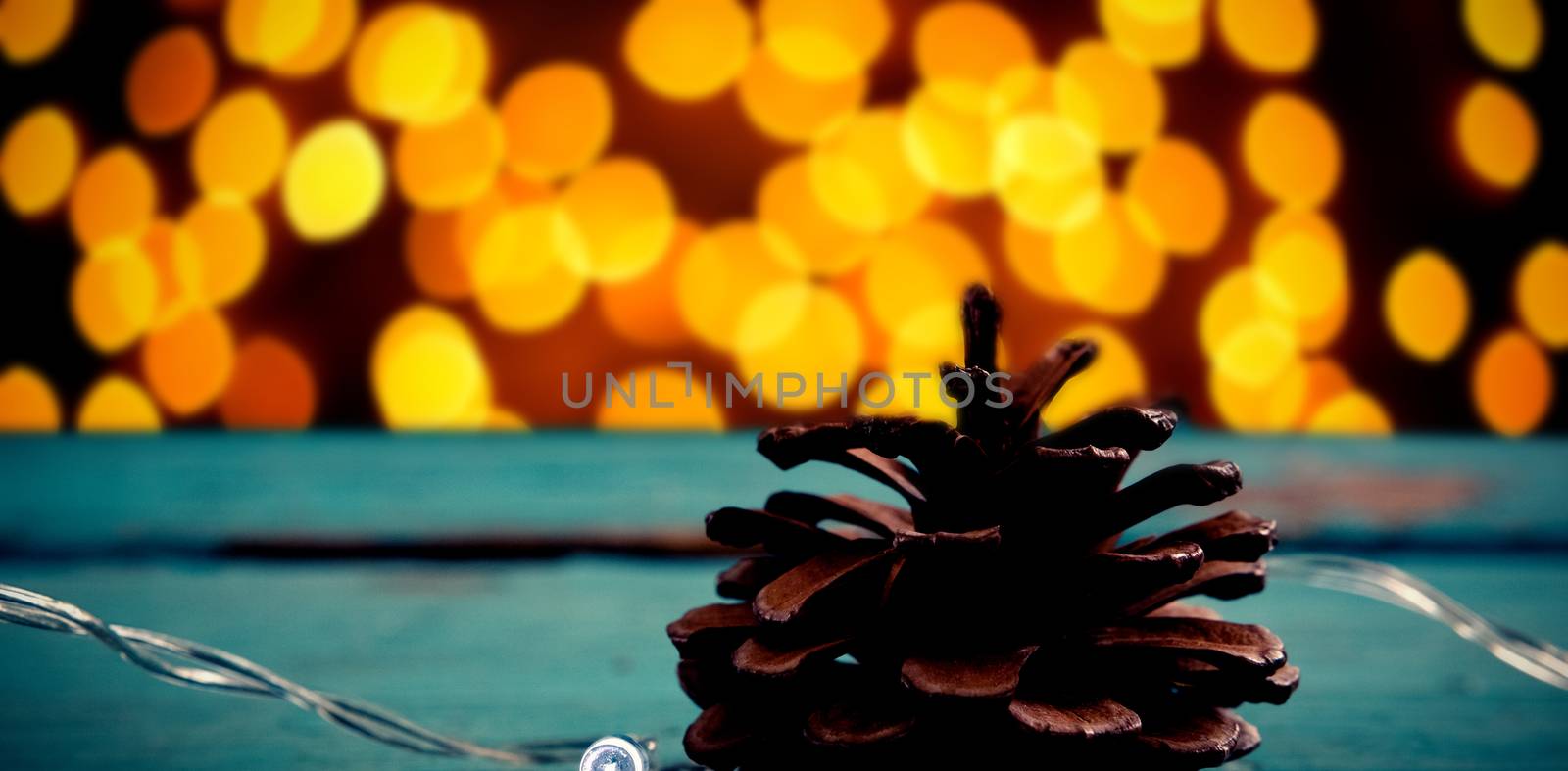 Composite image of pine cone decorated with christmas light by Wavebreakmedia