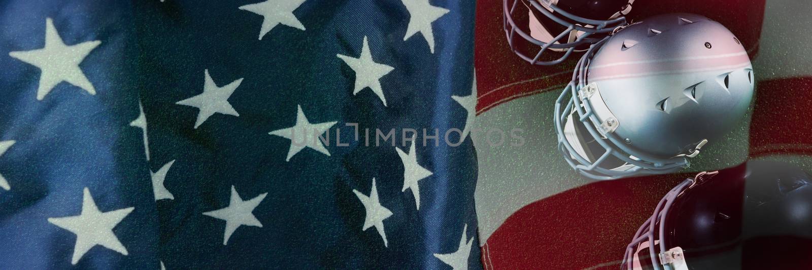 High angle view of American football head gears against close-up of an american flag