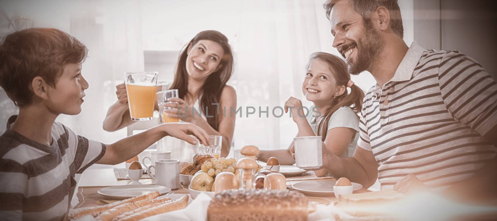 Happy family having breakfast by Wavebreakmedia